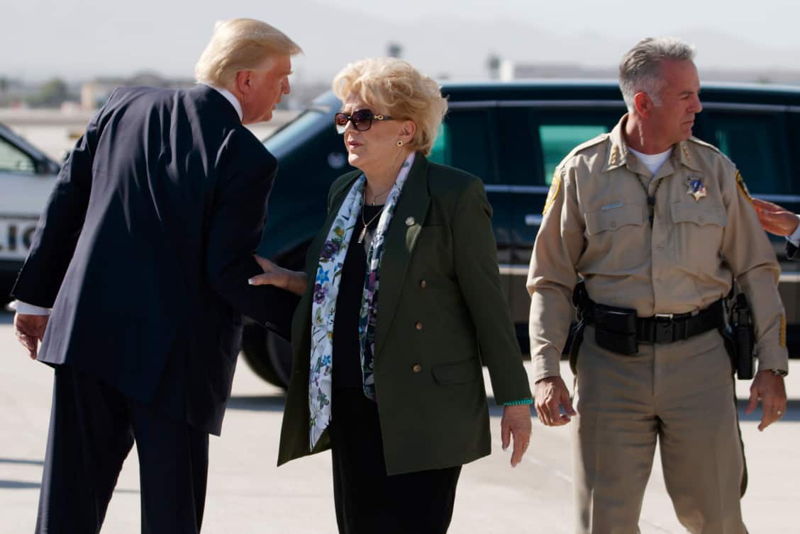 President Donald Trump talks with Las Vegas Mayor Carolyn Goodman and Clark County Sheriff Joseph Lombardo after arriving in Las Vegas. 