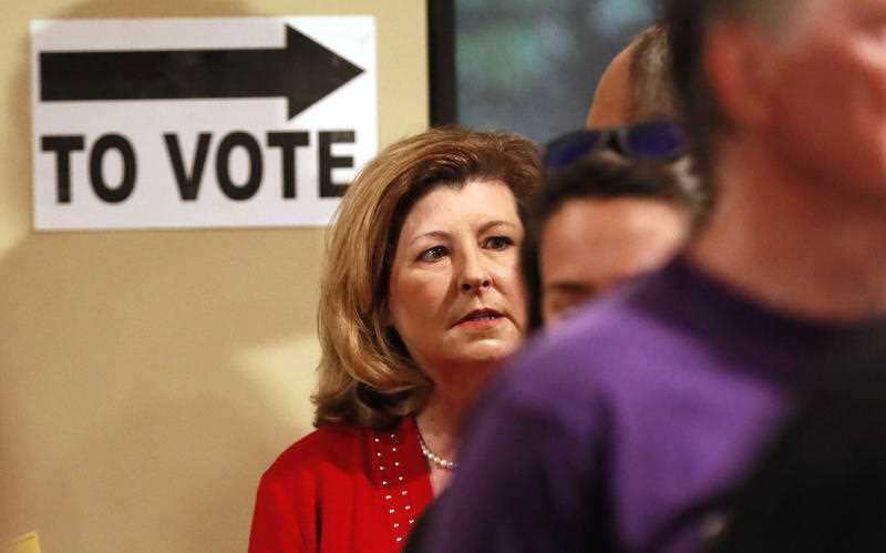 Republican Representative Karen Handel waits in line to vote at the St Mary's Orthodox Church in Roswell.