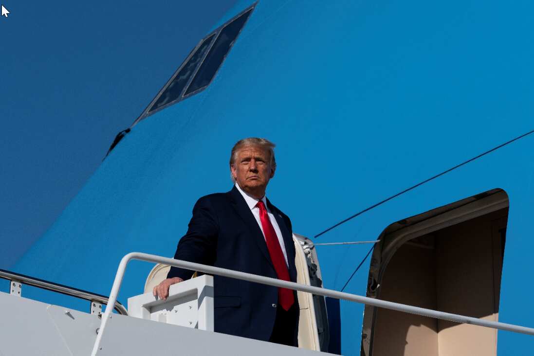 President Donald Trump pauses while boarding Air Force One as he departs Monday for Ohio.