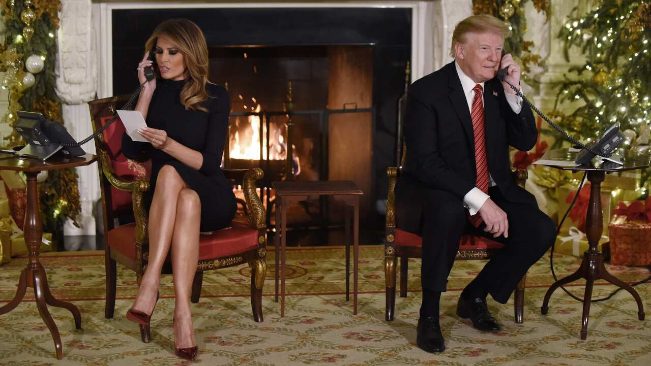 US President Donald Trump and the First Lady Melania Trump participate in NORAD Santa Tracker phone calls in the East Room of the White House.