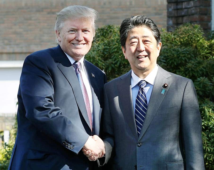US President Donald Trumpand Japanese Prime Minister Shinzo Abe shake hands at Kasumigaseki Country Club in Kawagoe.