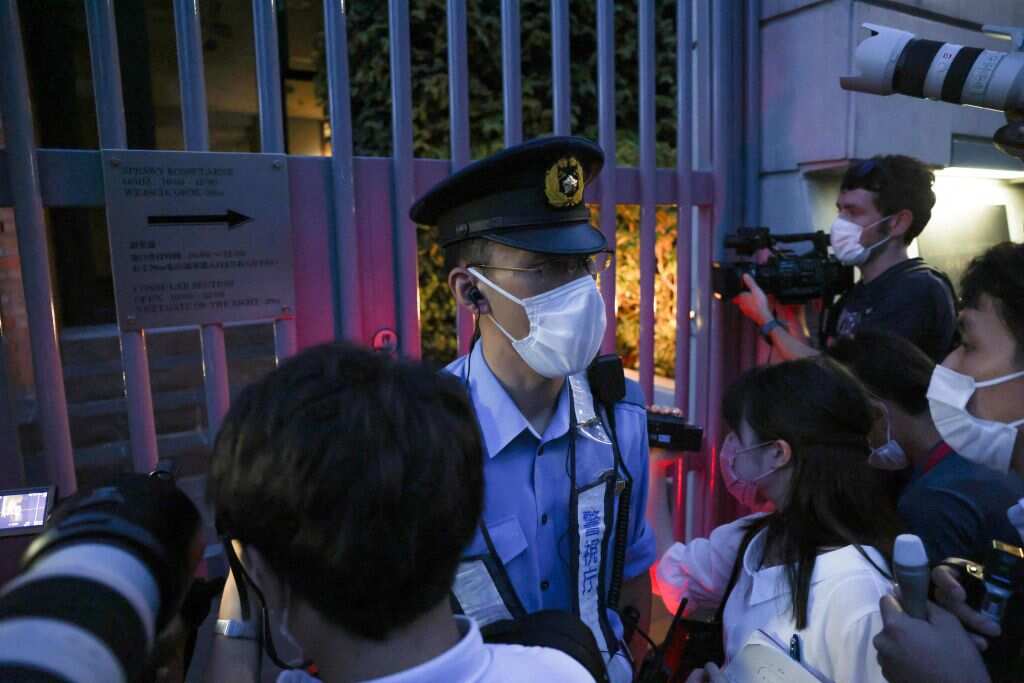 A policeman keeps watch as journalists gather outside the gates of the Polish embassy, where Belarus athlete Krystsina Tsimanouskaya is taking refuge.