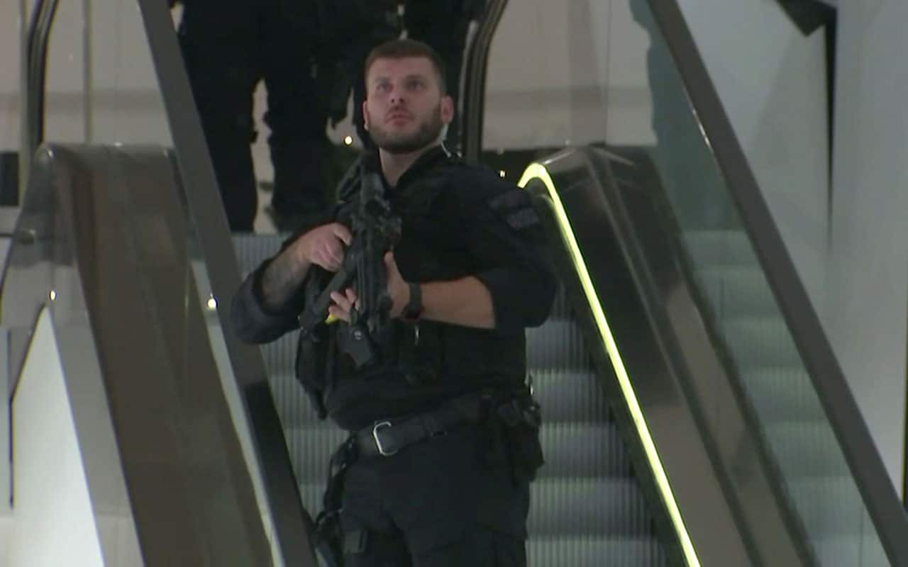 An armed police office patrols a department store, near to Oxford Street, in London.