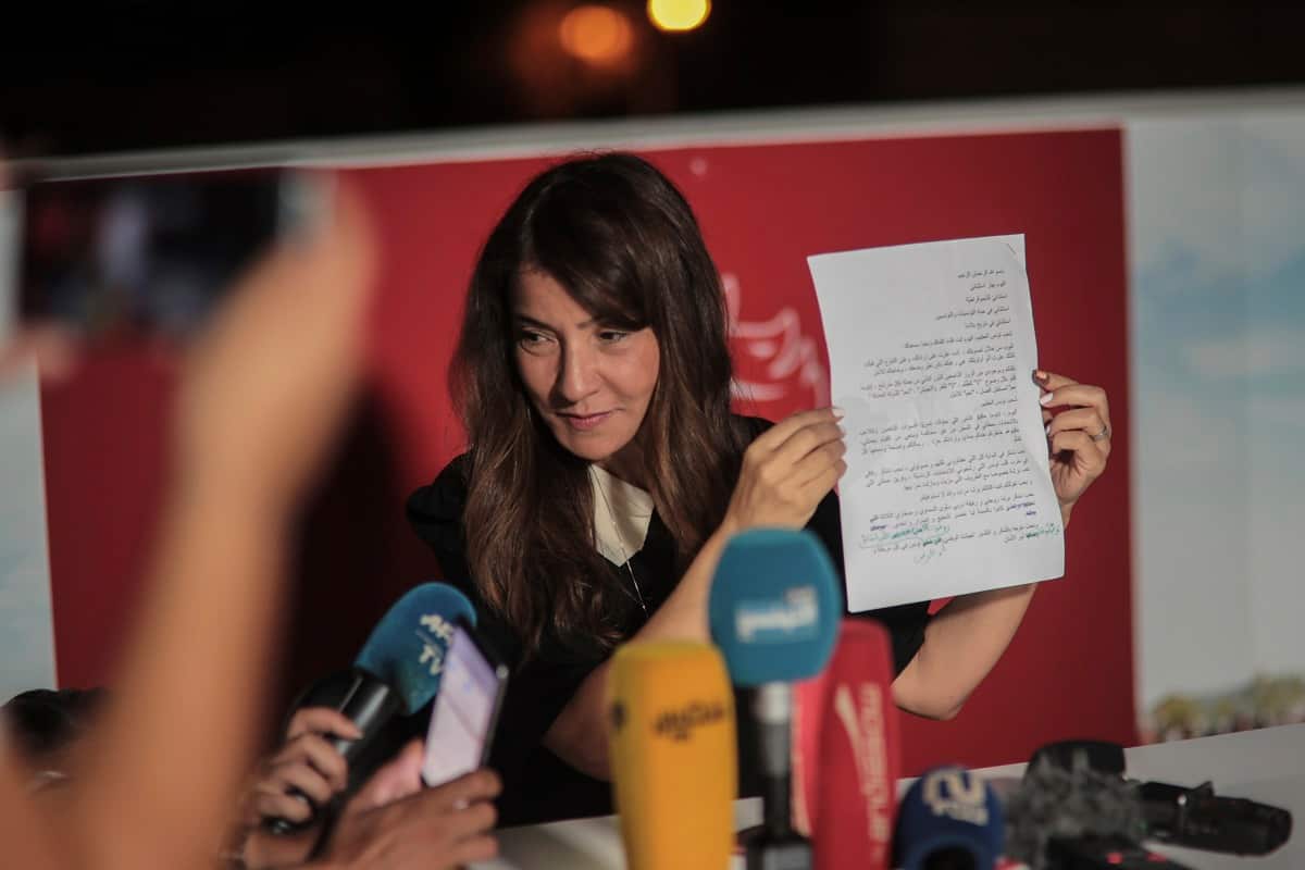 Salwa Karoui, wife of Tunisia's jailed presidential candidate and media mogul Nabil Karoui, displays a letter he wrote, during a presser in Tunis, Tunisia, Sunday Sept. 15, 2019.
