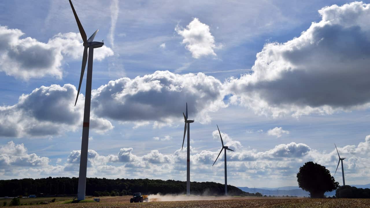 Wind turbines turn in a wind farm near Mihla, Germany.