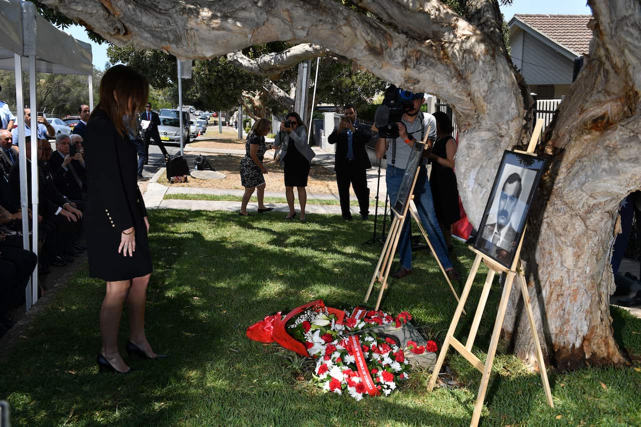 Ms Aryak lays a wreath at a memorial service for her father and his bodyguard in Sydney today.