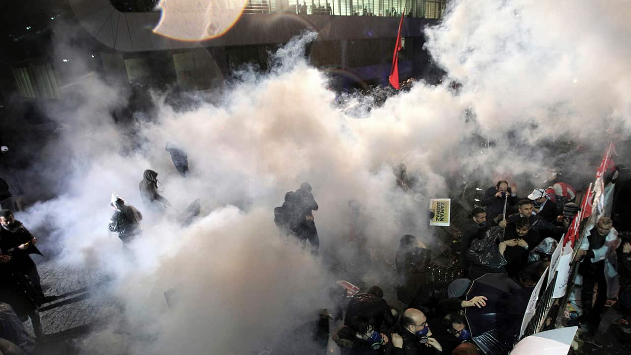 Riot police use tear gas against people gathered outside the Zaman newspaper headquarters in Istanbul in March.