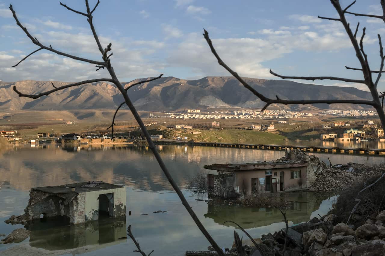 The rising waters of the Tigris River floods the old town of Hasankeyf, Turkey, with he new town in the background, Feb. 23, 2020.
