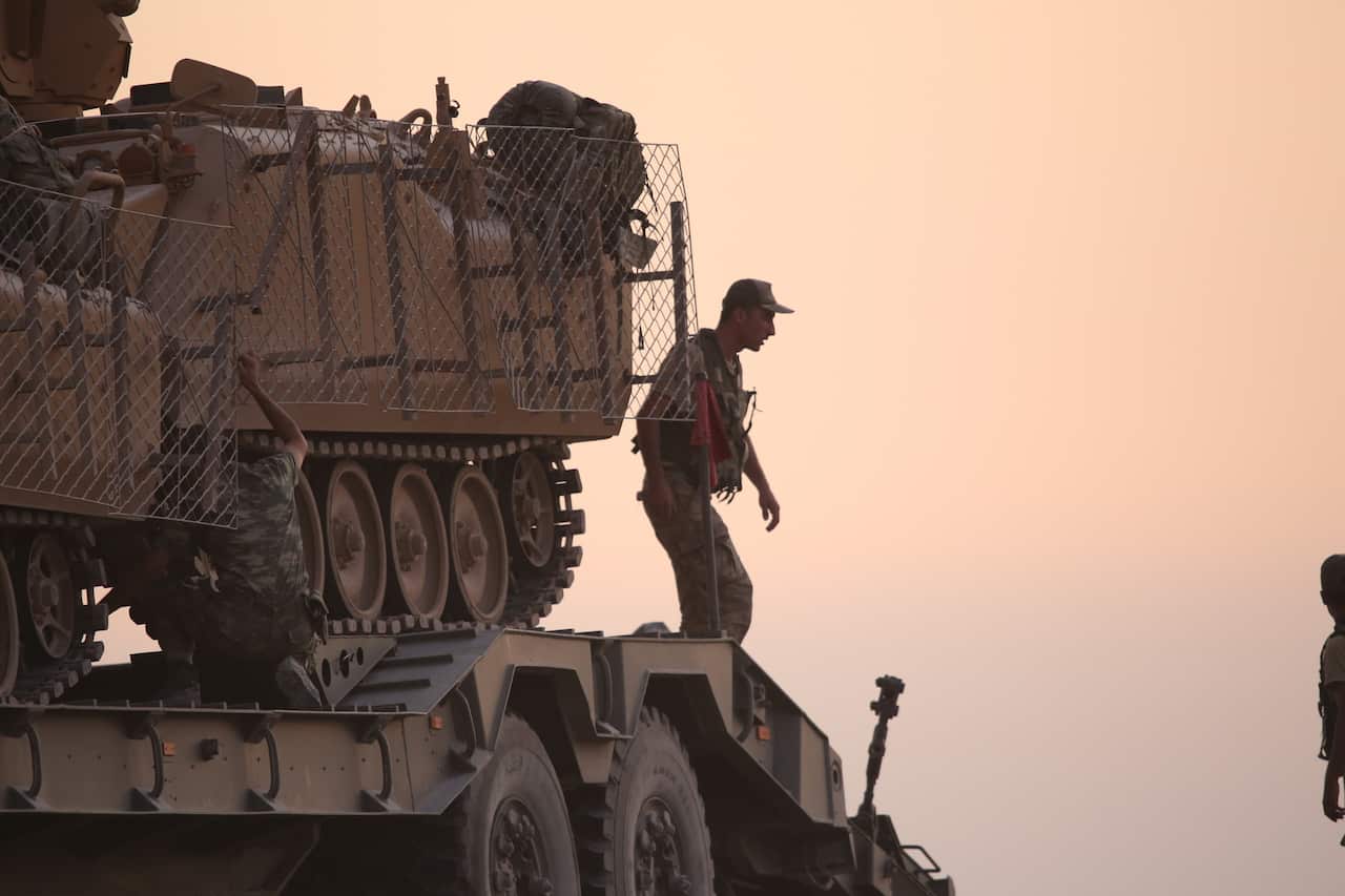 Turkish soldiers with armored vehicles and tanks during a military operation in Kurdish areas of northern Syria.