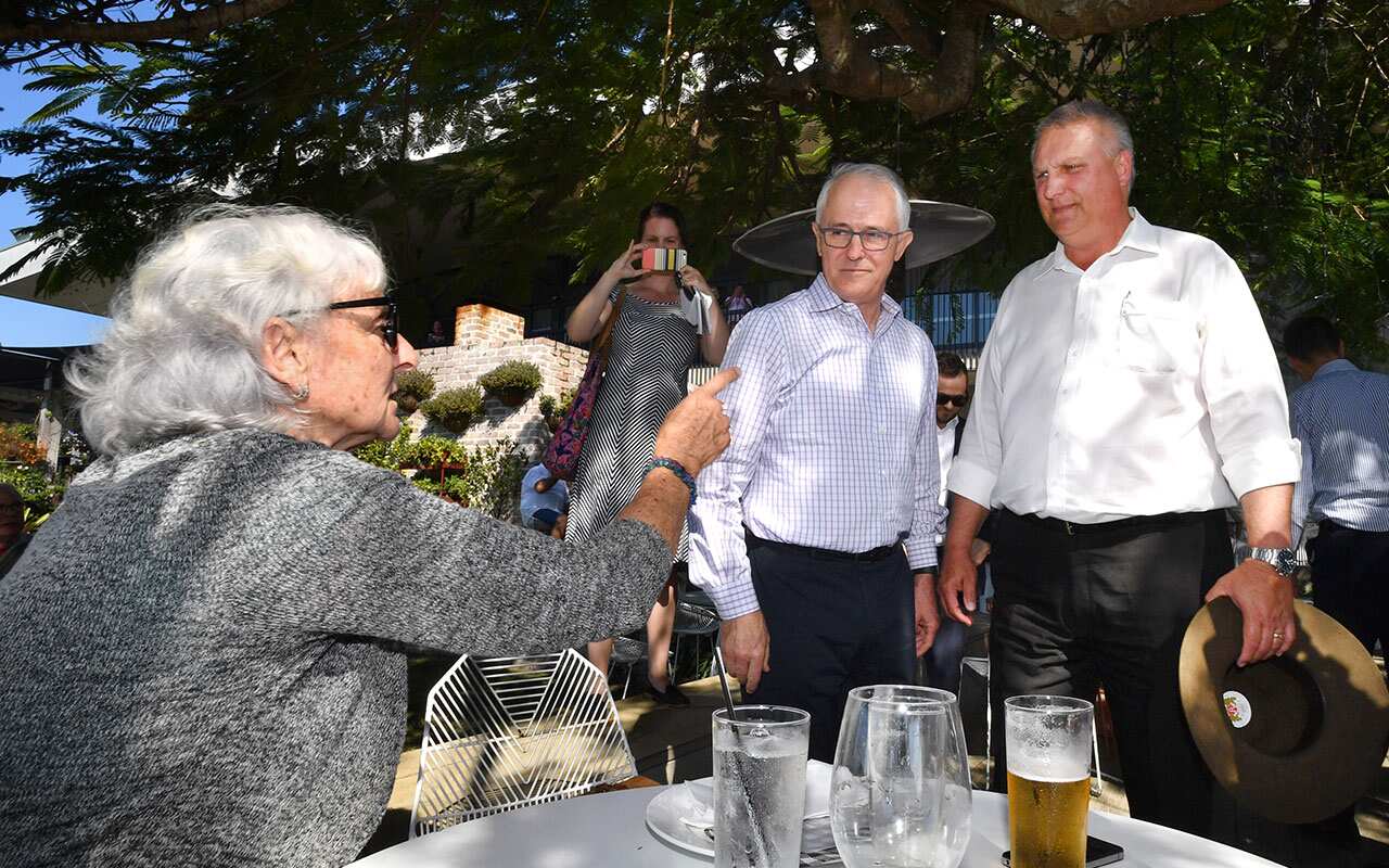 Local resident Toni Lea (left) is seen gesturing at Prime Minister Malcolm Turnbull (centre) and Trevor Ruthenberg on Friday at Sandstone Point. 