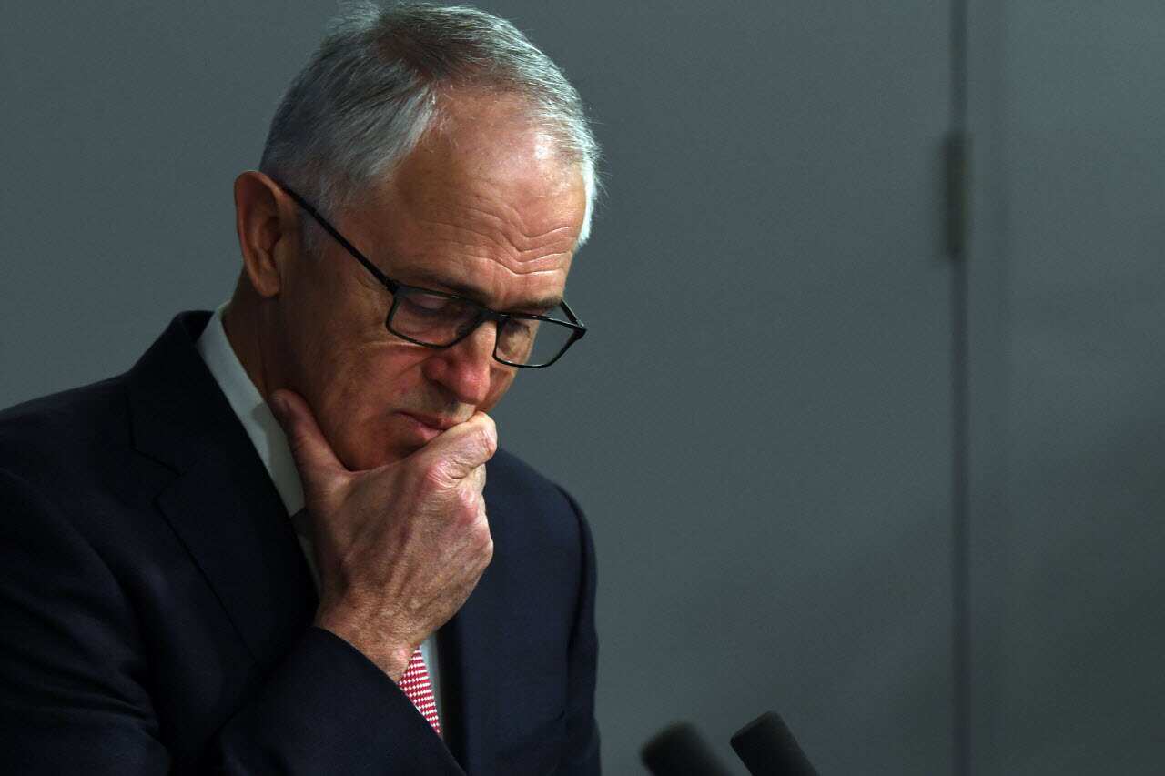 Malcolm Turnbull reacts at a press conference on Sunday following the alleged raids.