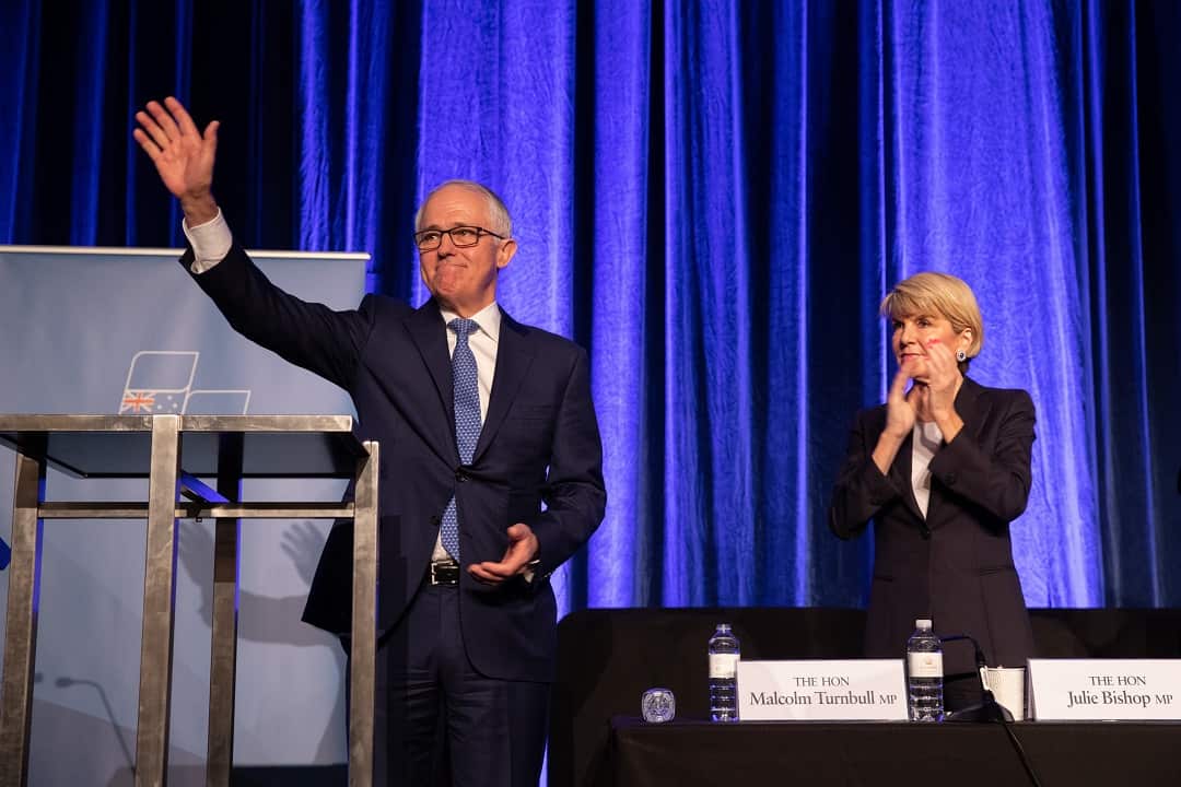 Prime Minister Malcolm Turnbull waves to supporters alongside Minister for Foreign Affairs Julie Bishop after speaking at the WA Liberal Party State Conference in Perth on Saturday, August 11, 2018. (AAP Image/Richard Wainwright) NO ARCHIVING