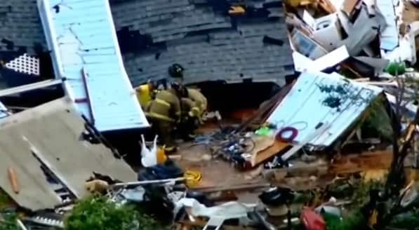 Rescuers pull an injured resident from a destroyed house in Elk City, Oklahoma.
