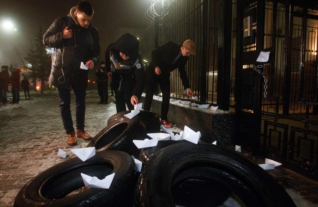 Protestors place paper ships on the tyres during their rally near the Russian embassy in Kiev.