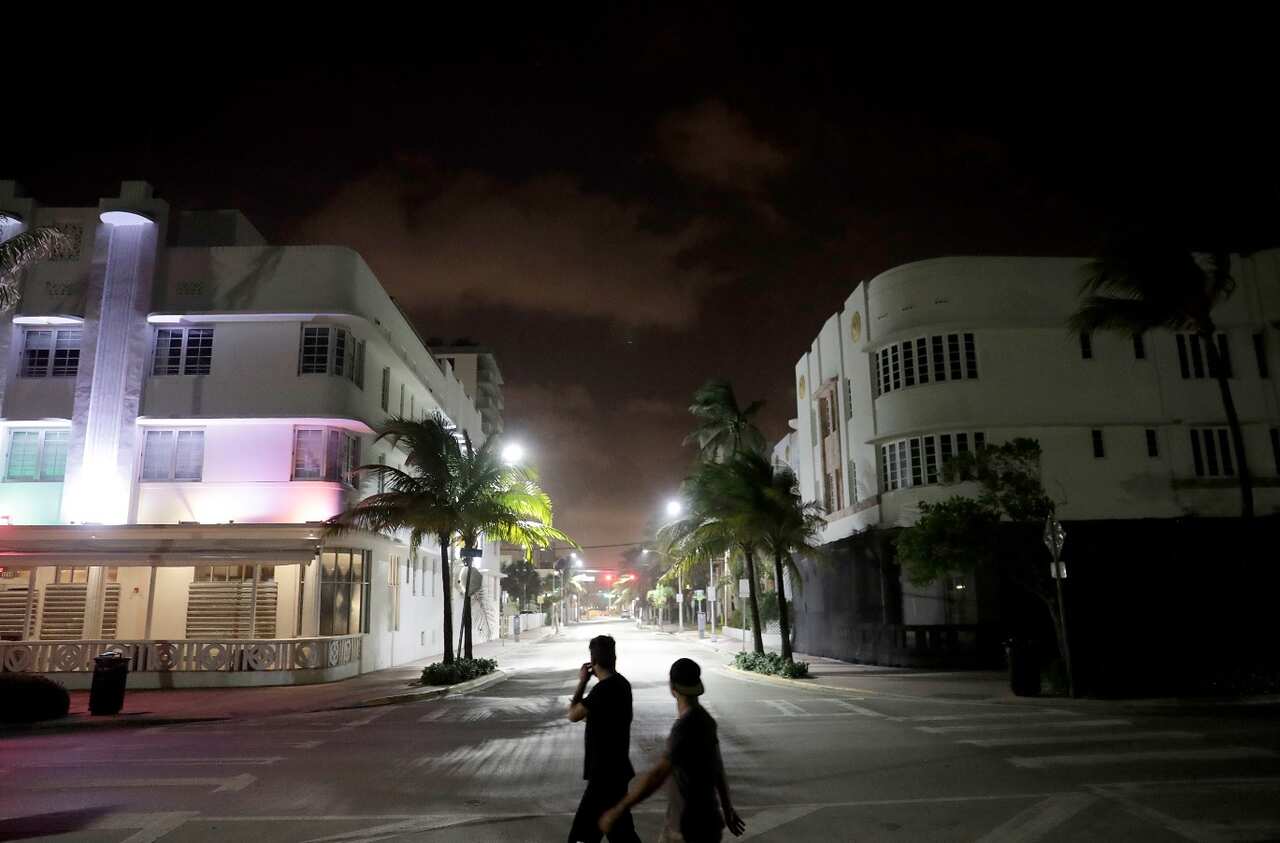 Pedestrians walk through the usual bustling South Beach ahead of Hurricane Irma in Miami Beach, Fla., Friday, Sept. 8, 2017. 