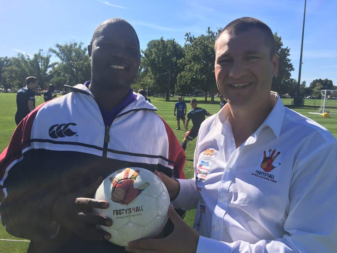Ugandan school principal Daniel Male surprises charity worker Michael Gallus in Melbourne. 