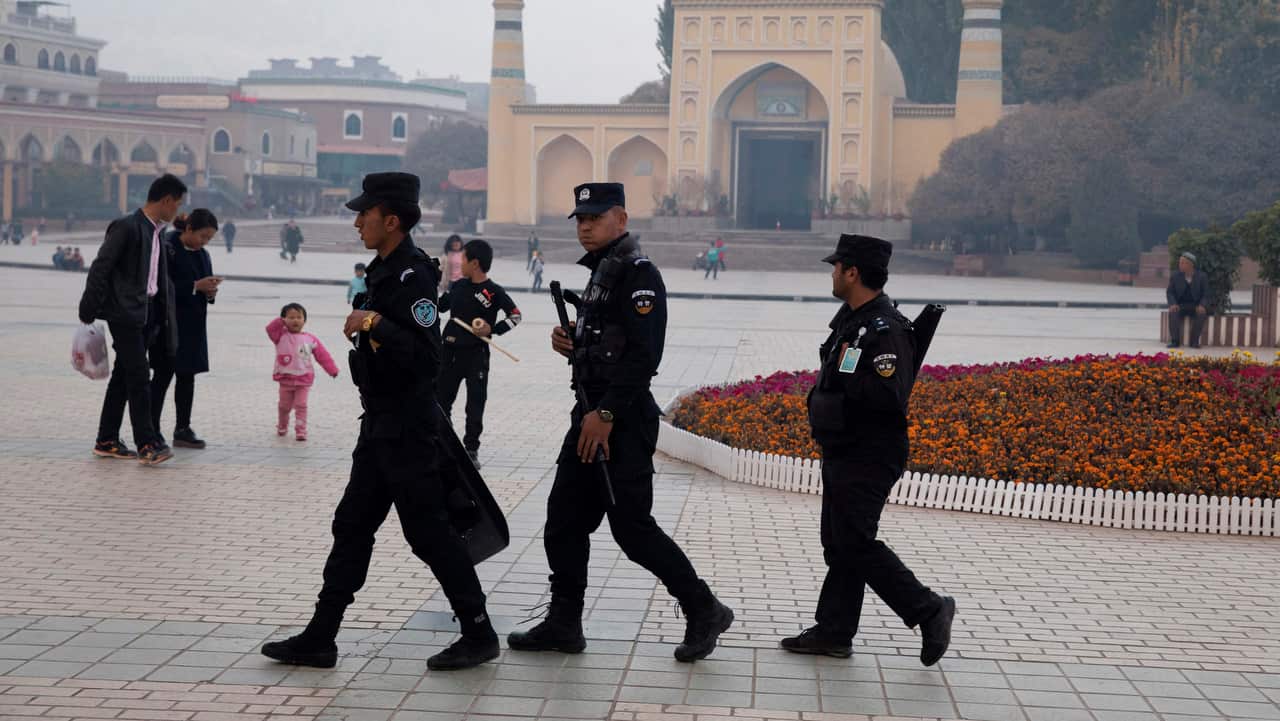 Uighur security personnel patrol near the Id Kah Mosque in Kashgar in western China's Xinjiang region on 4/11/17.