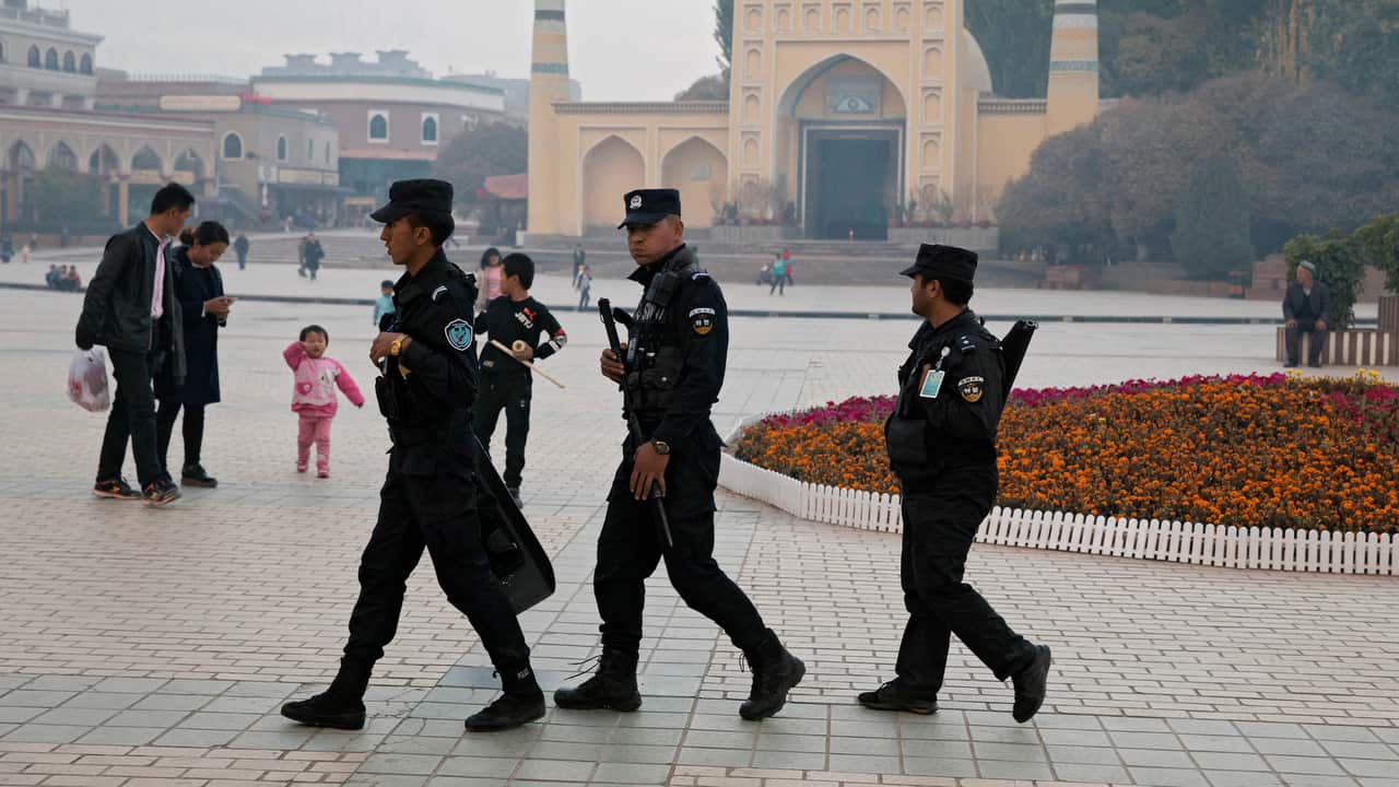 Uighur security personnel patrol near the Id Kah Mosque in Kashgar in western China's Xinjiang region.  