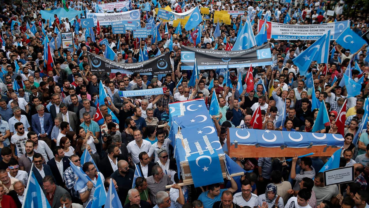 Uighurs living in Turkey and their supporters chant slogans as they stage a protest in Istanbul.