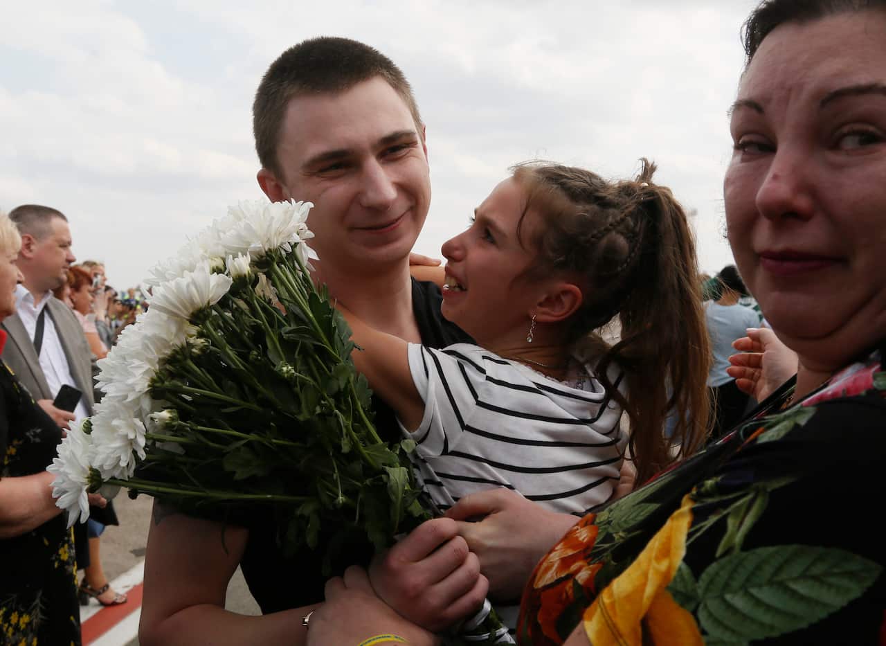 Relatives of Ukrainian prisoners freed by Russia greet them upon their arrival at Boryspil airport, outside Kyiv.