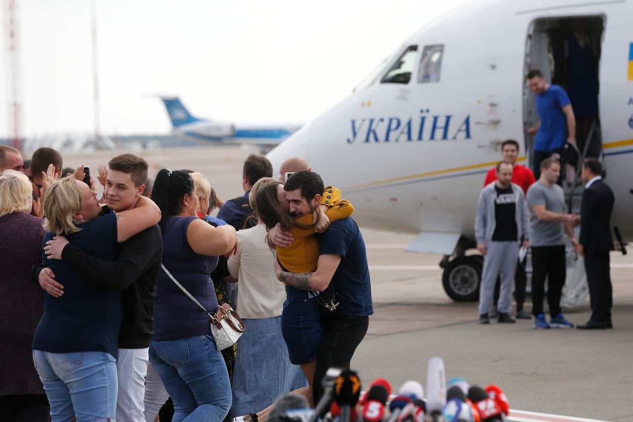 Planes carrying prisoners freed by Russia and Ukraine land in the countries' capitals.