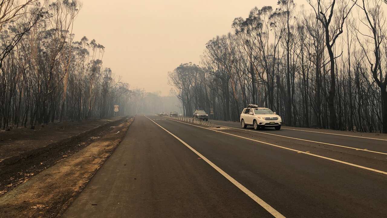 Burnt-out bush land surrounds the Princes Highway in Ulladulla on 2 January 2020.  