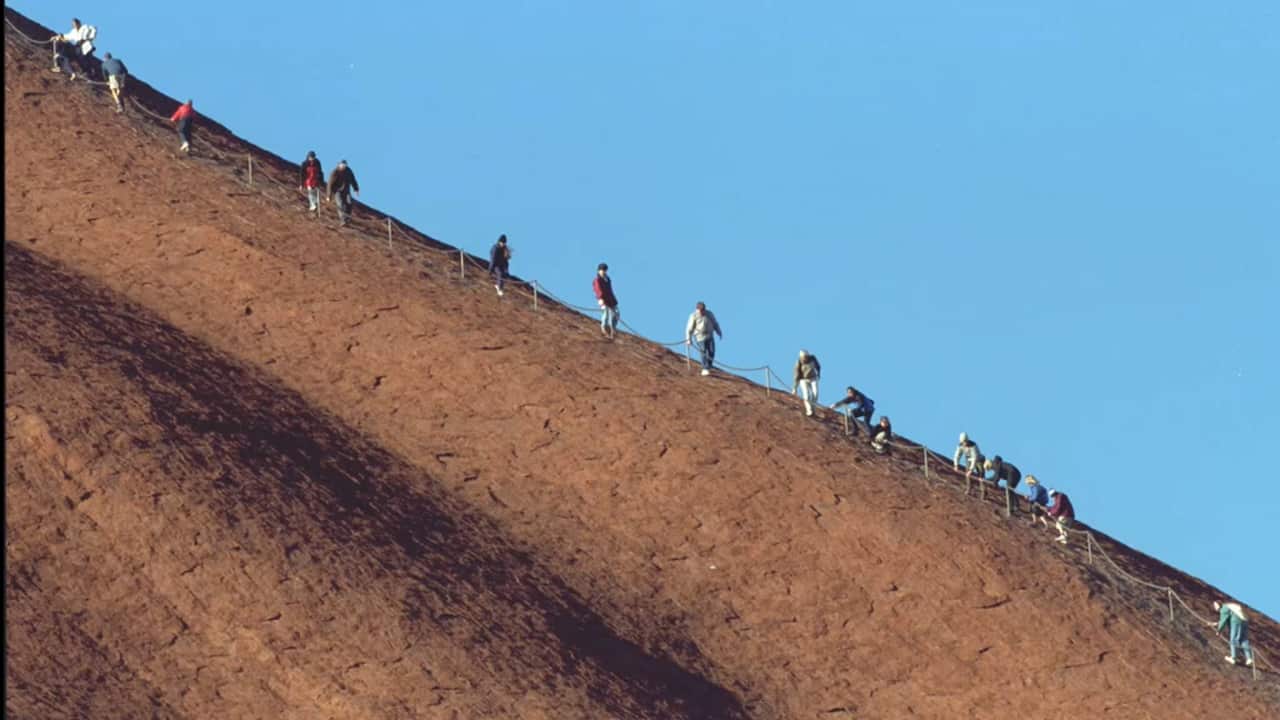 People climbing Uluru