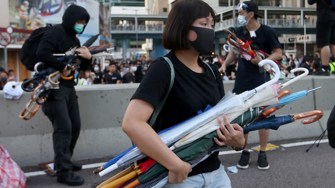 Protesters carry many umbrellas as they occupy a section of Harcourt Road close to the legislative Council.