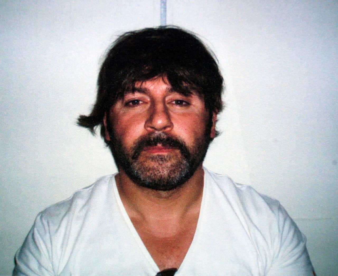 Tony Mokbel wearing the trademark wig he used while on the run, after his arrest in Athens in 2007.