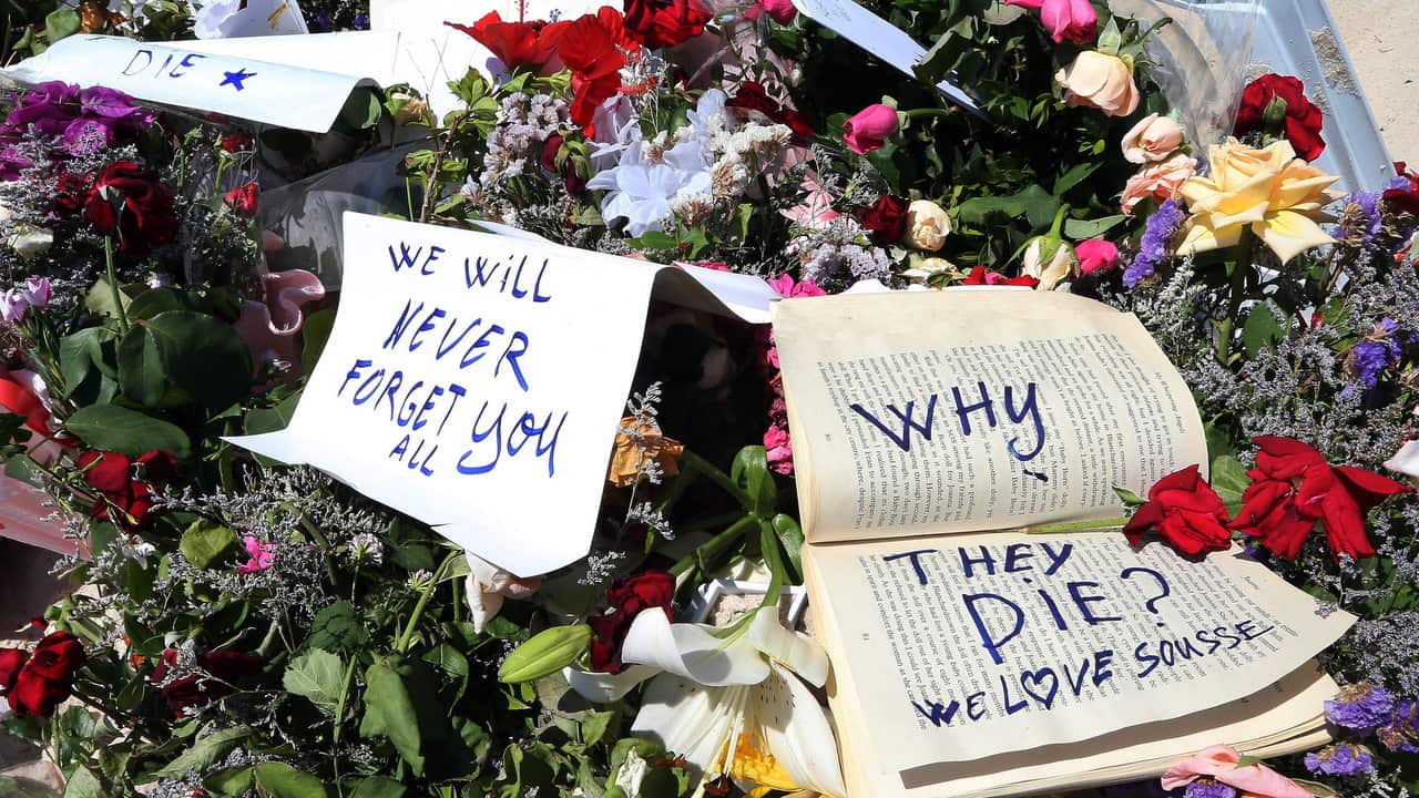 Flowers and cards are placed in tribute to the victims of a terror attack on a beach in front of the imperial Marhaba Hotel in Sousse.