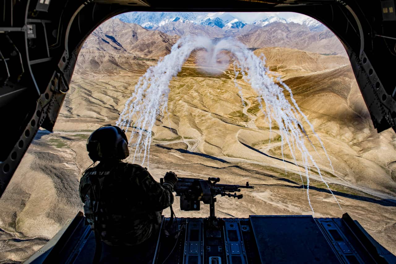 A U.S. Army crew chief observes a flare test during a training flight in Afghanistan.