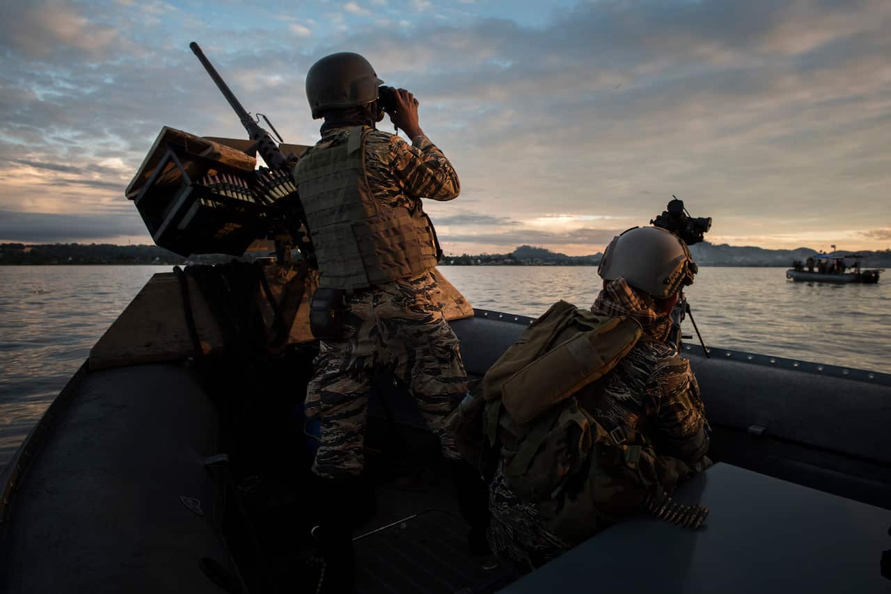Philippines naval special forces patrol a lake near the main battle area in the southern Philippine city of Marawi
