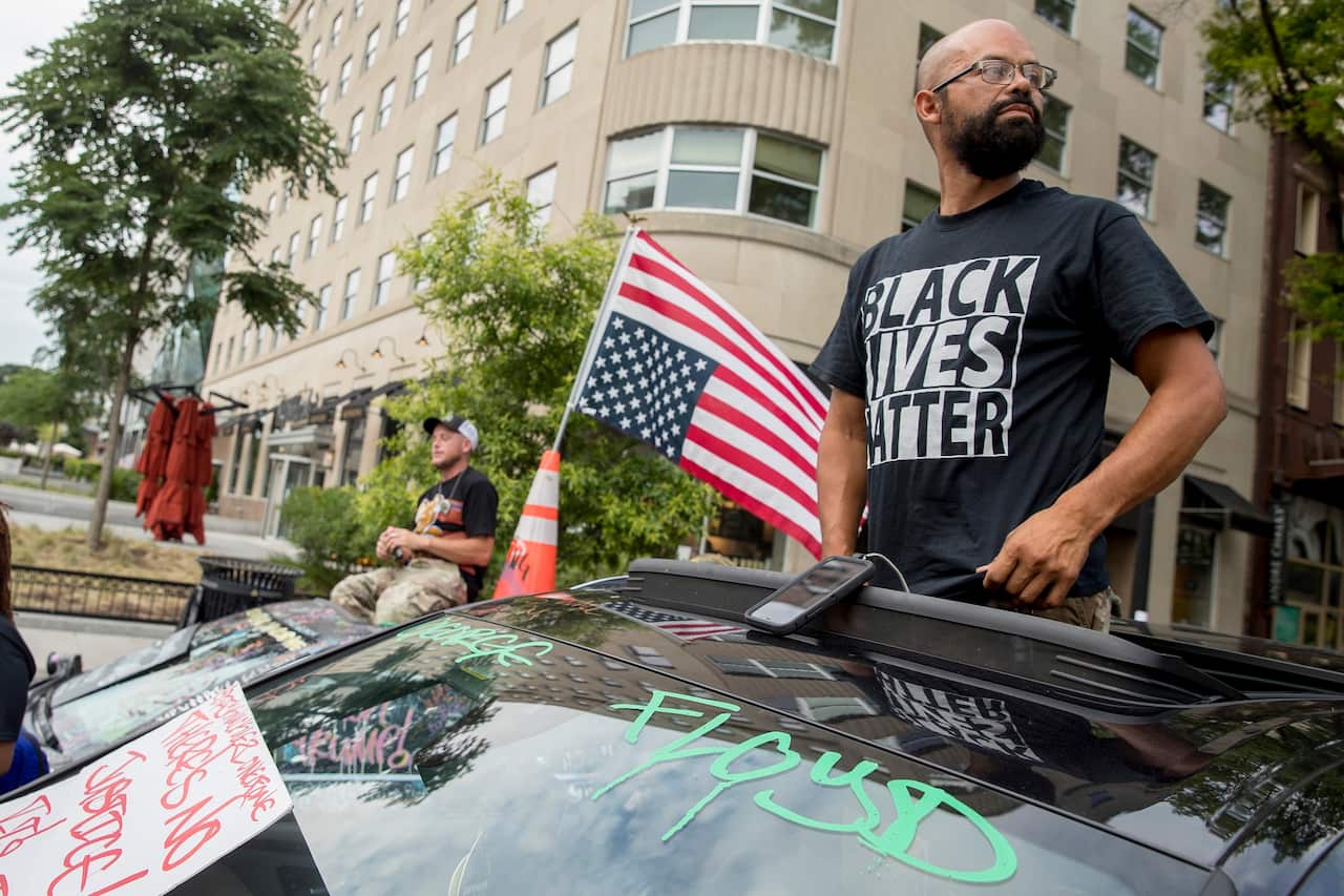 George Floyd's name is written on a car windshield as protester John Coy attends a protest near the White House.