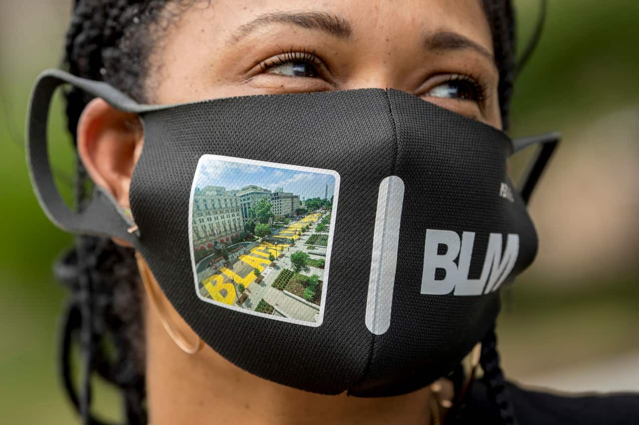 Shawna Jacobs wears a mask with a photograph of 16th Street Northwest renamed Black Lives Matter Plaza in Washington.