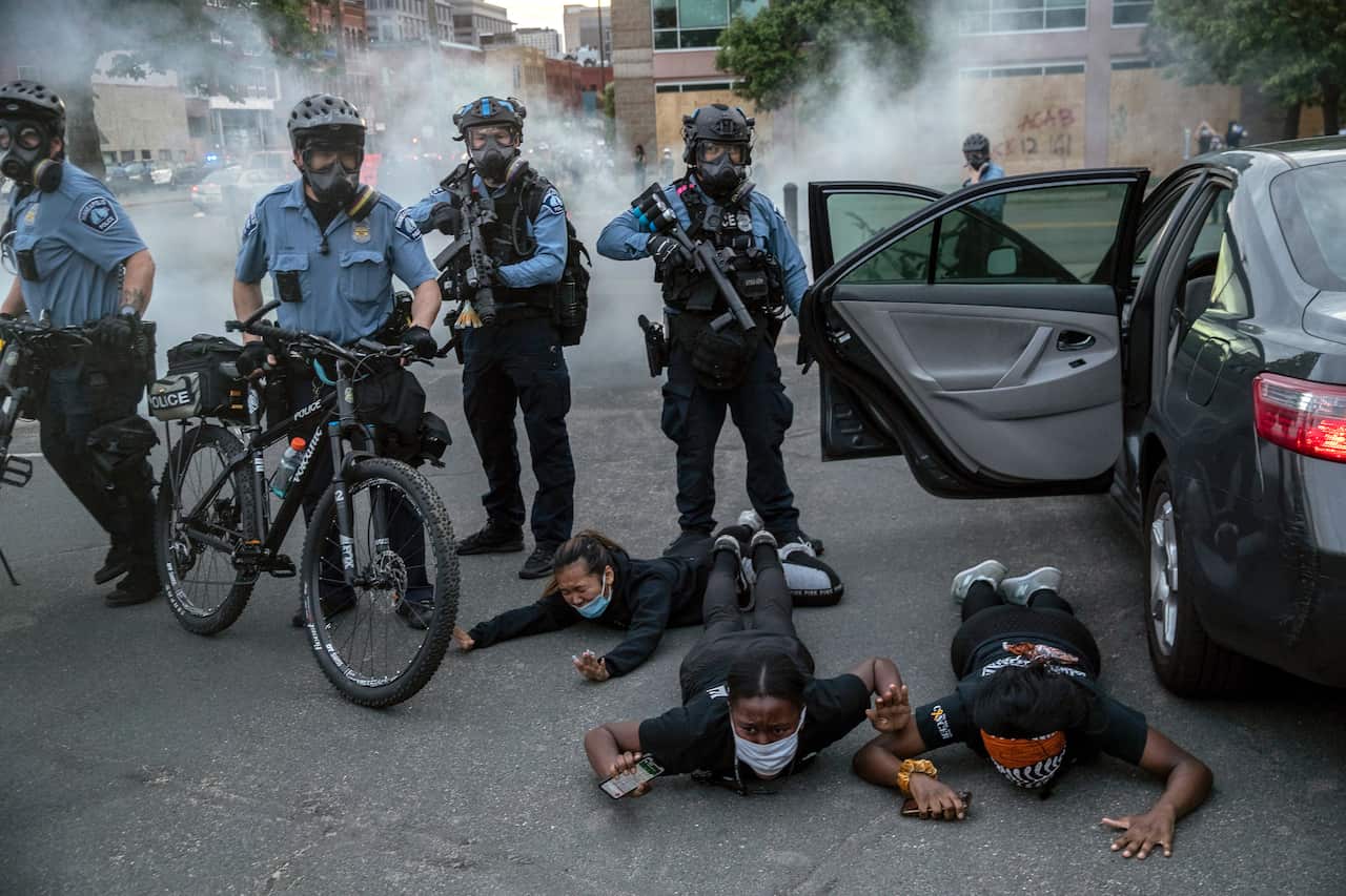 Protesters are detained by the police in Minneapolis on Sunday, May 31, 2020. 
