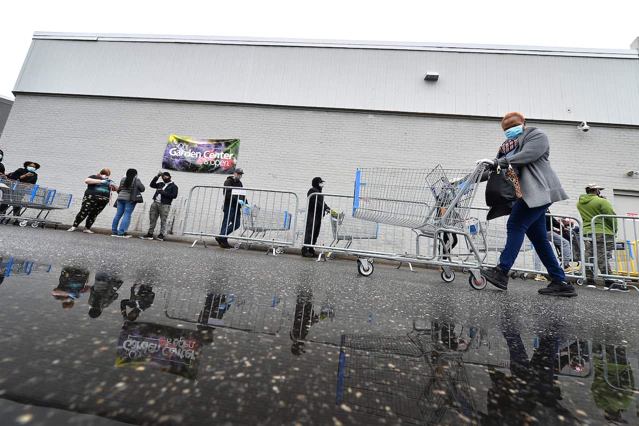 A woman wearing a face mask as required state order during the COVID-19 pandemic, shops at Walmart Supercenter in Brooklyn, NY. 