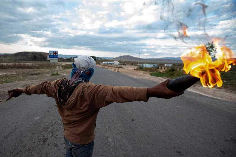 Opponents of Venezuelan President Nicolas Maduro clash with members of the Bolivarian National Guard of Venezuela at the border crossing.