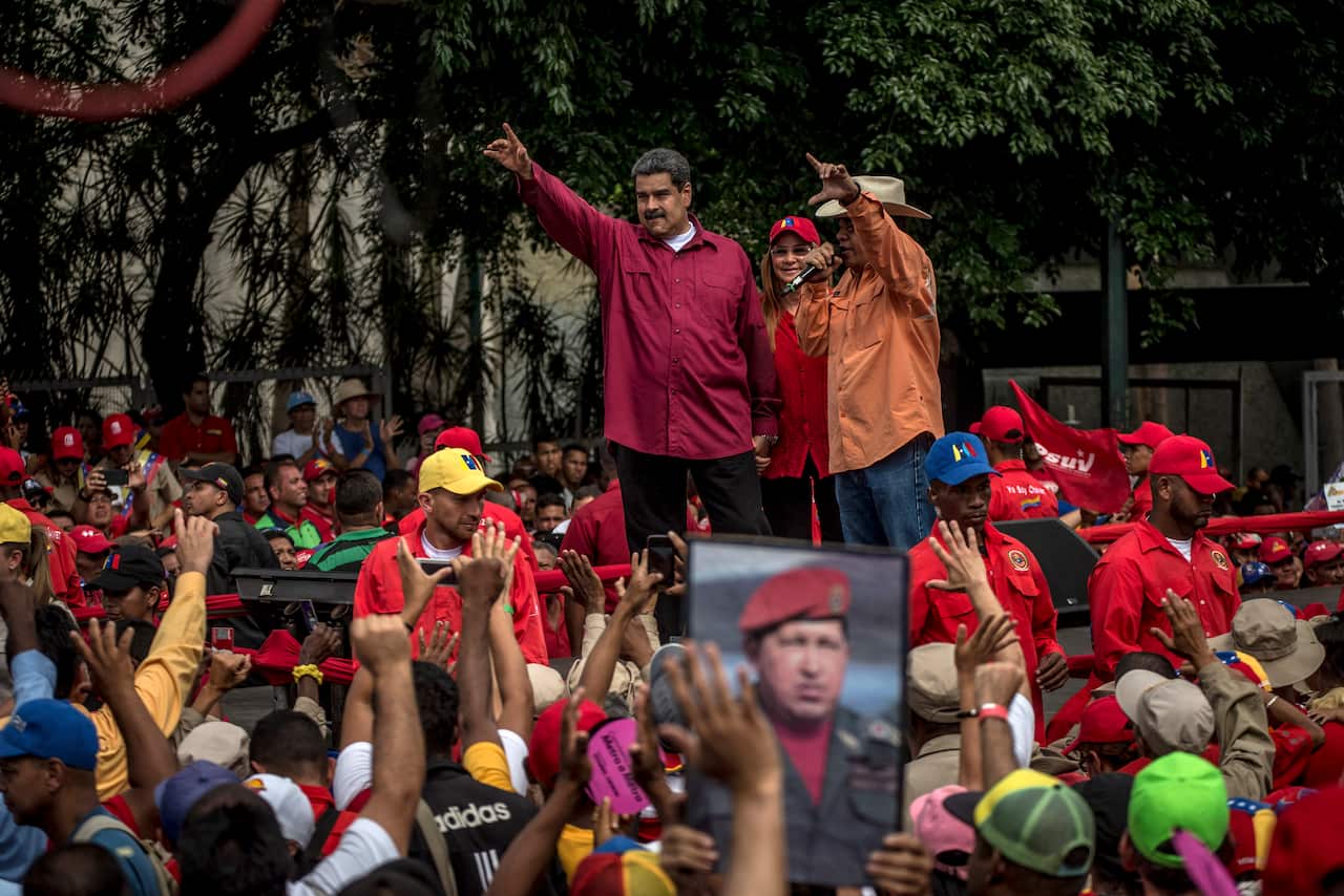 President Nicols Maduro waves to workers
