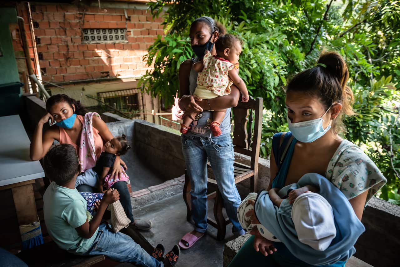 Mothers whose families are food insecure wait for meals at a local soup kitchen in Caracas, Venezuela, Dec. 8, 2020. (Meridith Kohut/The New York Times)
