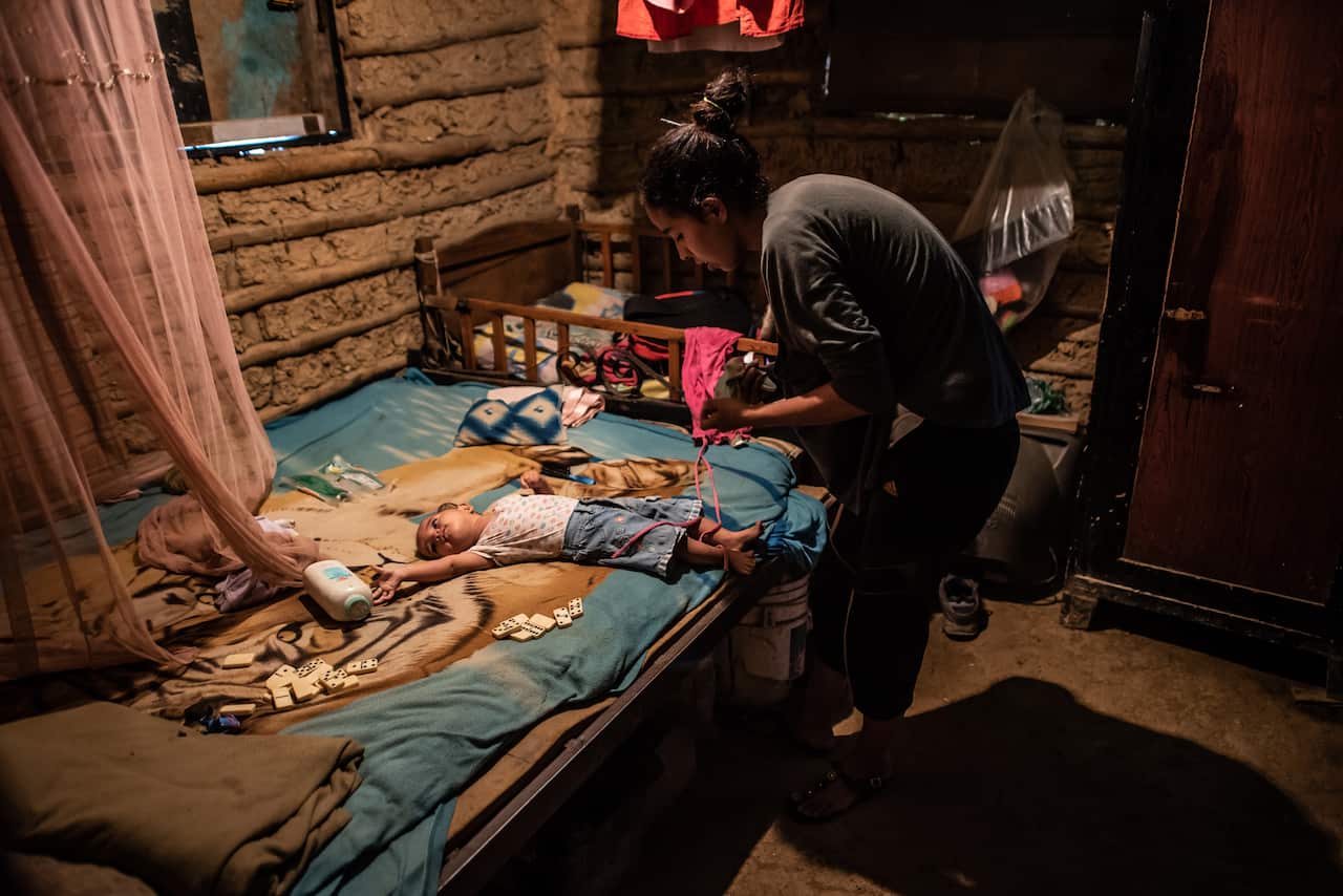 Johanna Guzman, 25, takes care of her children at her home in the mountains outside of Caracas, Venezuela, Dec. 7, 2020. (Meridith Kohut/The New York Times)