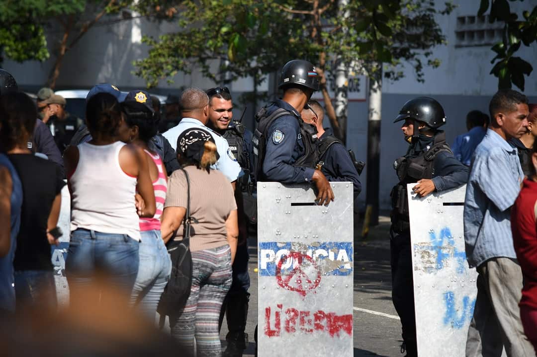 Officers stand guard near the police station.