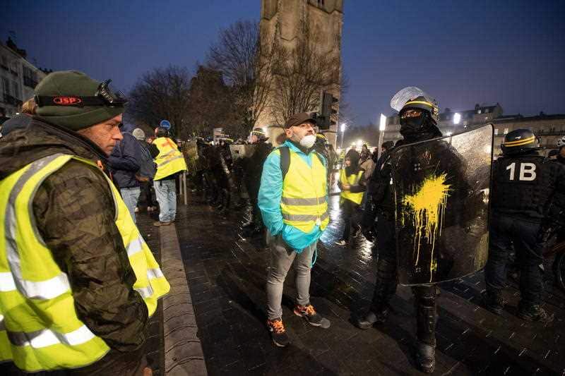 Yellow Vest protesters and riot police on the streets of Paris.