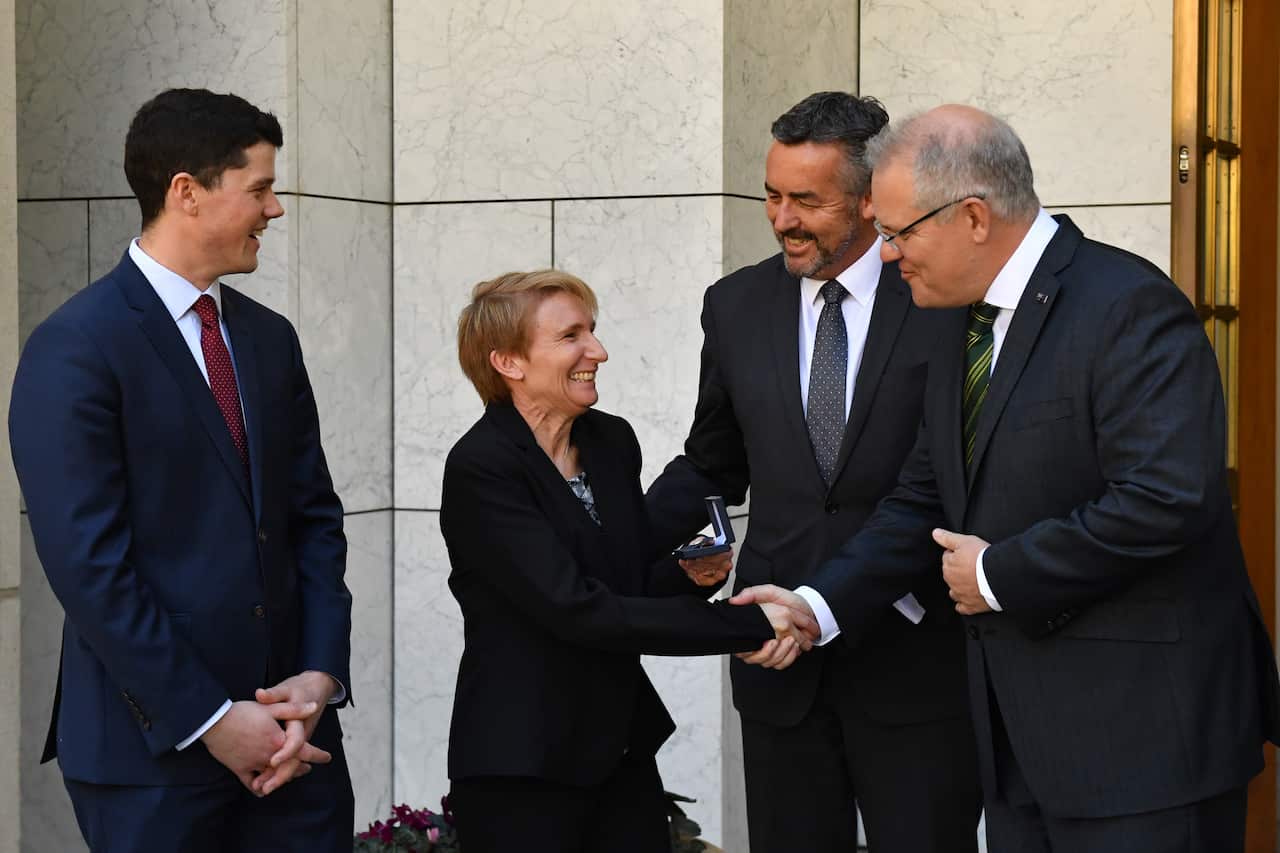 Prime Minister Scott Morrison present veterans (L-R) Jordon Ivone and Kelly Wright with a Veteran's Pin at Parliament House in Canberra last month.