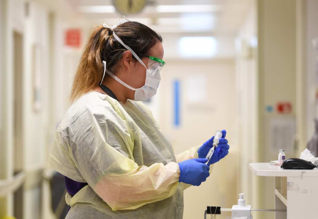 A healthcare worker conducts coronavirus screening inside a Melbourne hospital. 