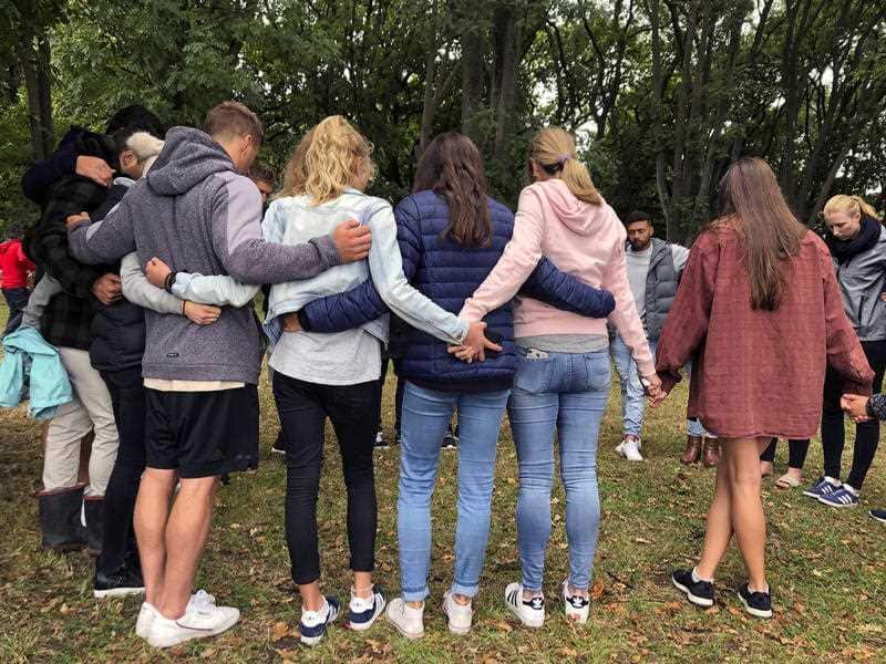 Mourners link arms in Hagley Park near the Al Noor mosque.