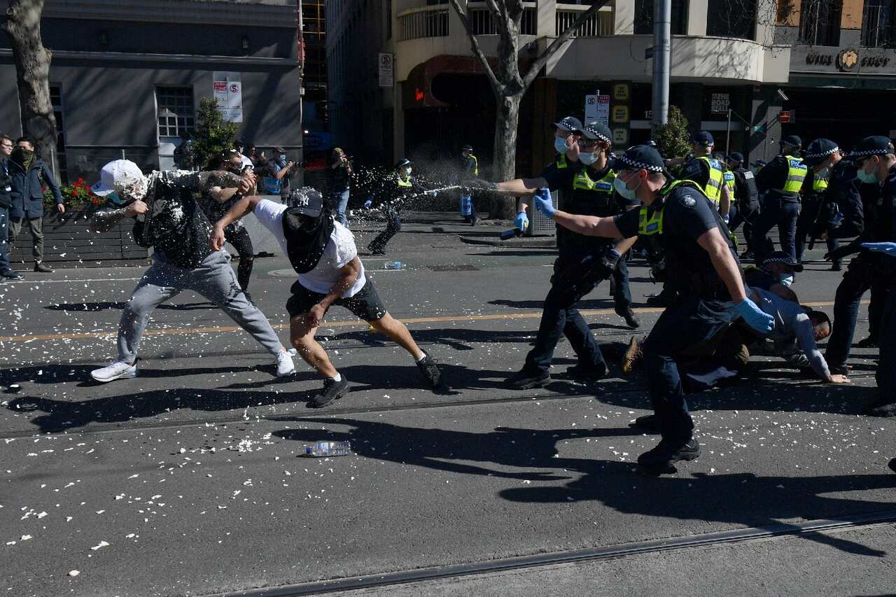 Protesters are pepper sprayed by police during an anti-lockdown protest in the central business district of Melbourne.