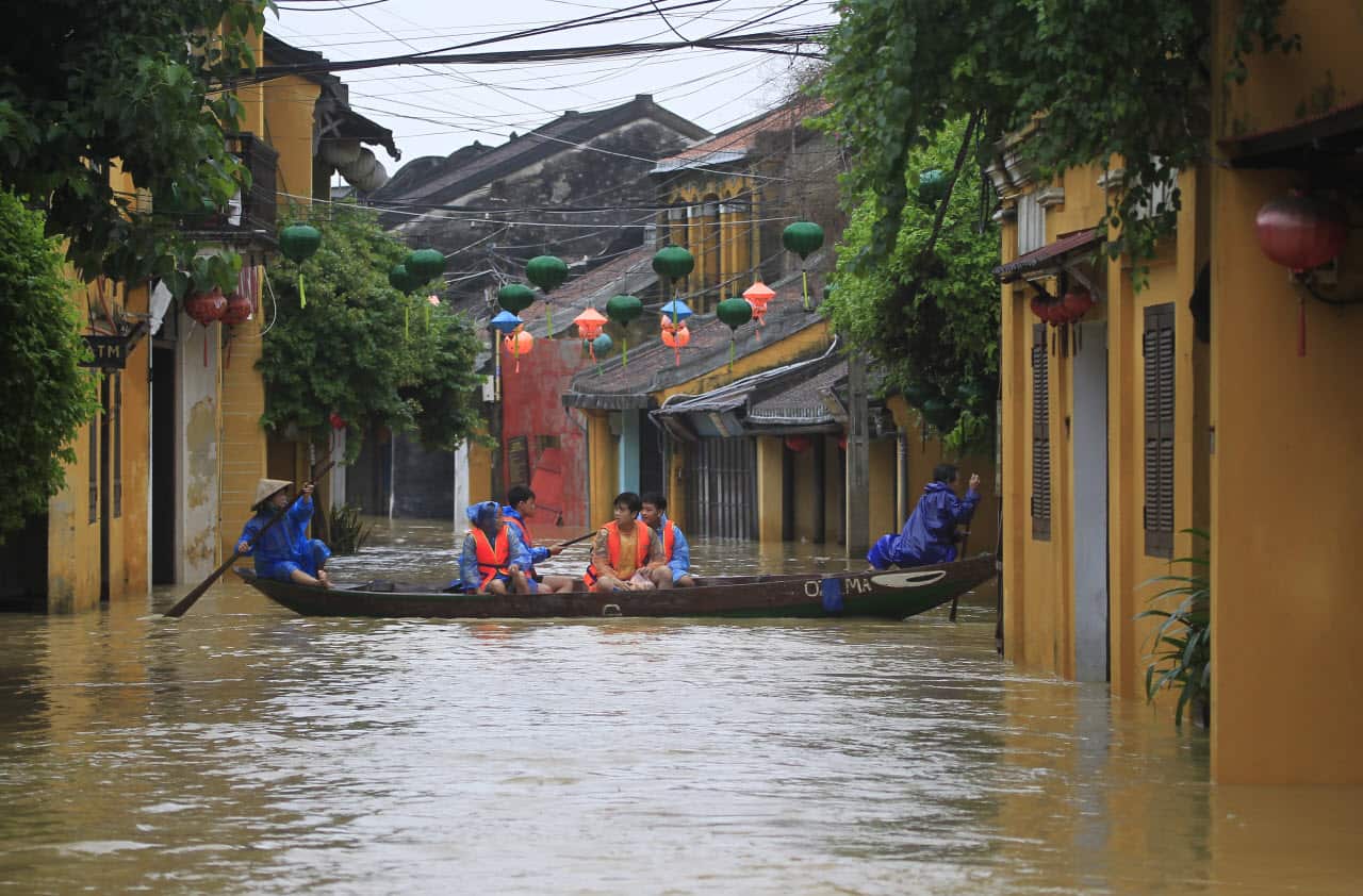 People ride a boat in flooded street in Hoi An, Vietnam, Monday, Nov. 6, 2017. 