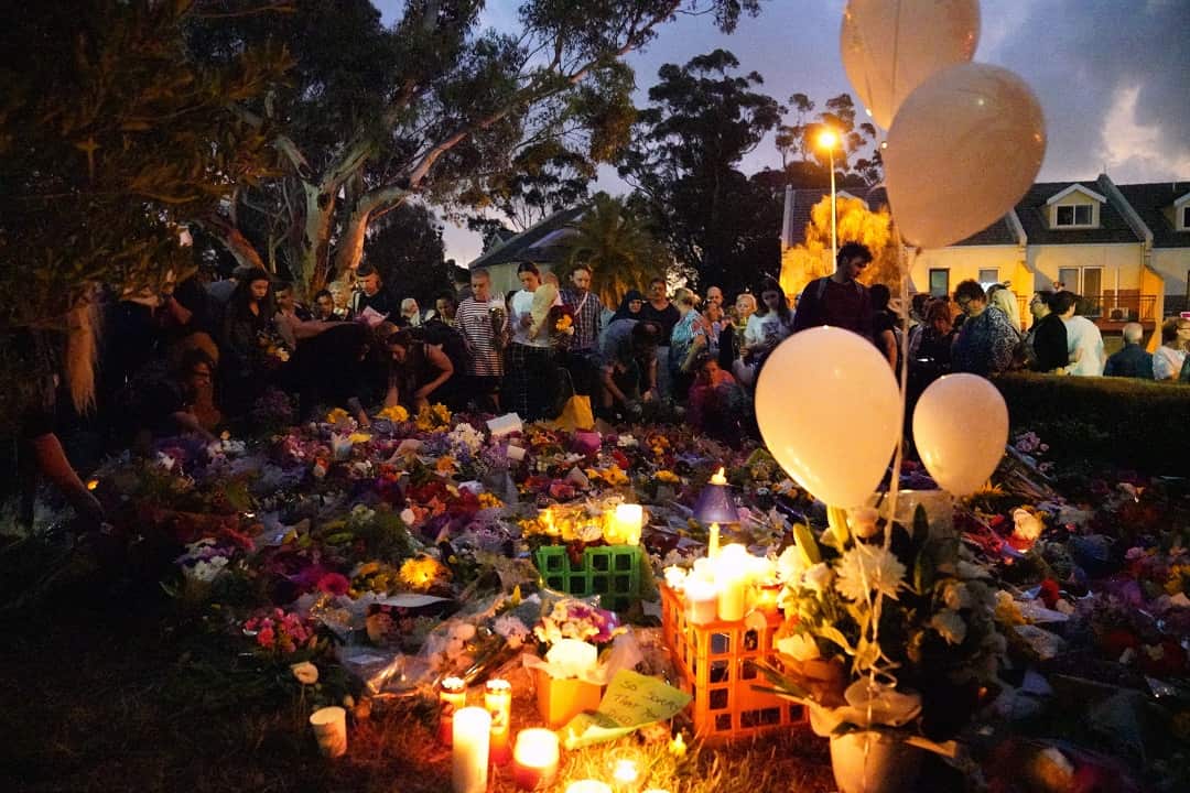 The site where the body of Aiia Maasarwe was found is surrounded by mourners and flowers in Bundoora.
