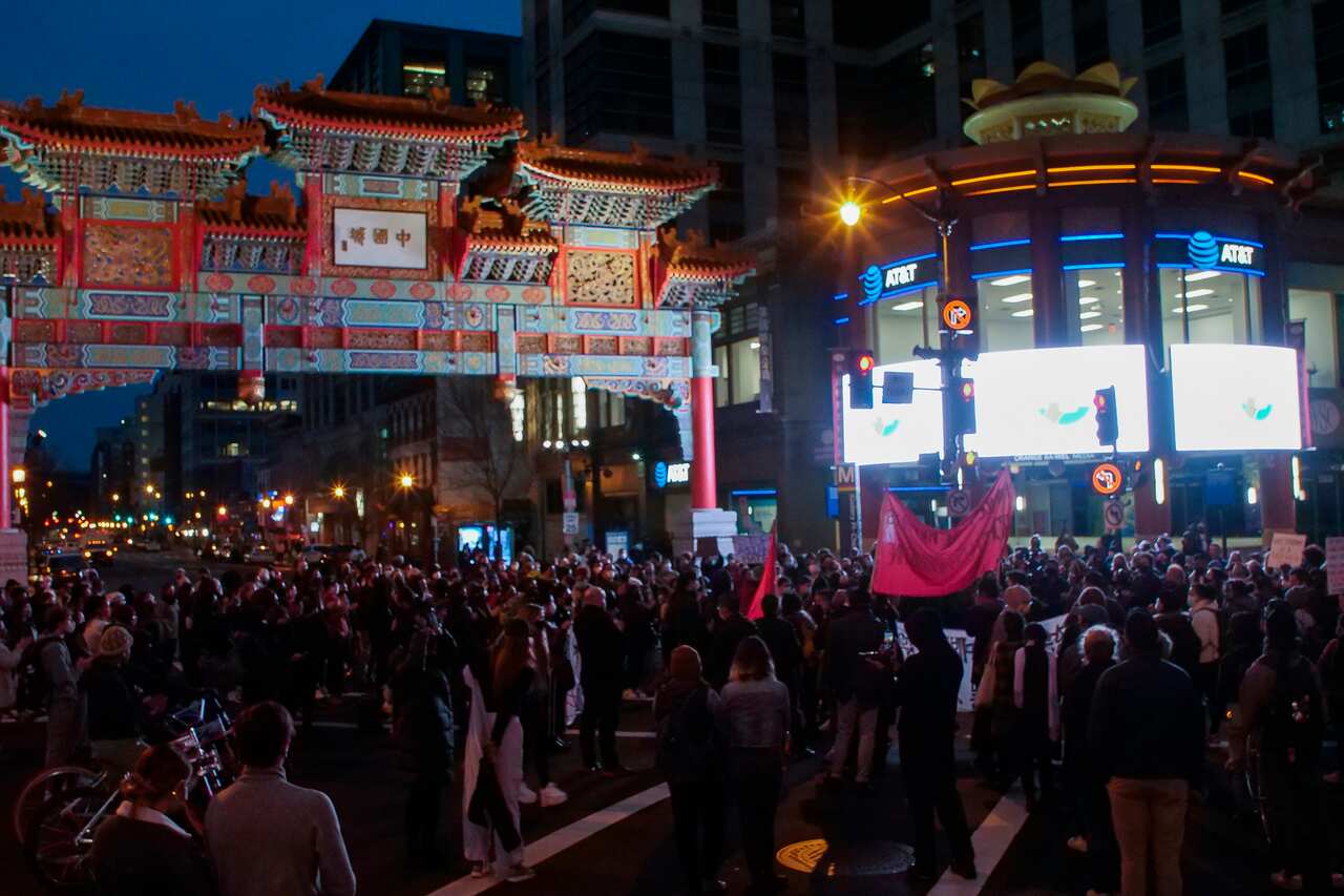 A group of people in Washington DC gather to mourn those killed at a spa in Atlanta, Georgia. 