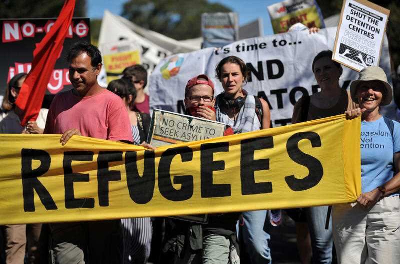 Refugee activists march around the Villawood detention centre as part of a protest. 